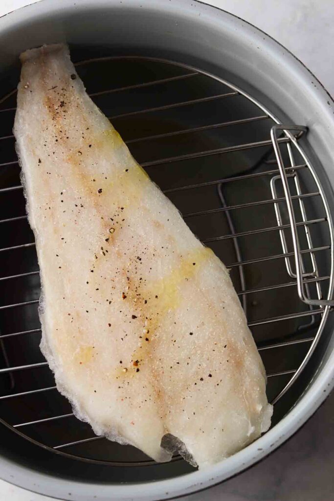 cod in the air fryer on a basket