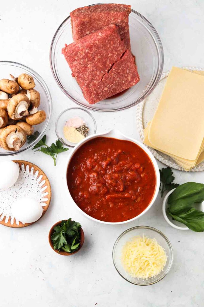 lasagna ingredients laid out in bowls