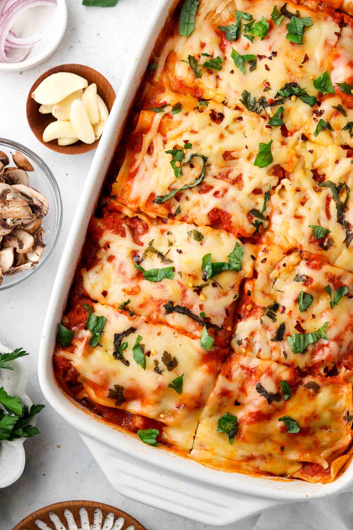 Lasagna with gluten free noodles and cashew cheese in a casserole dish.