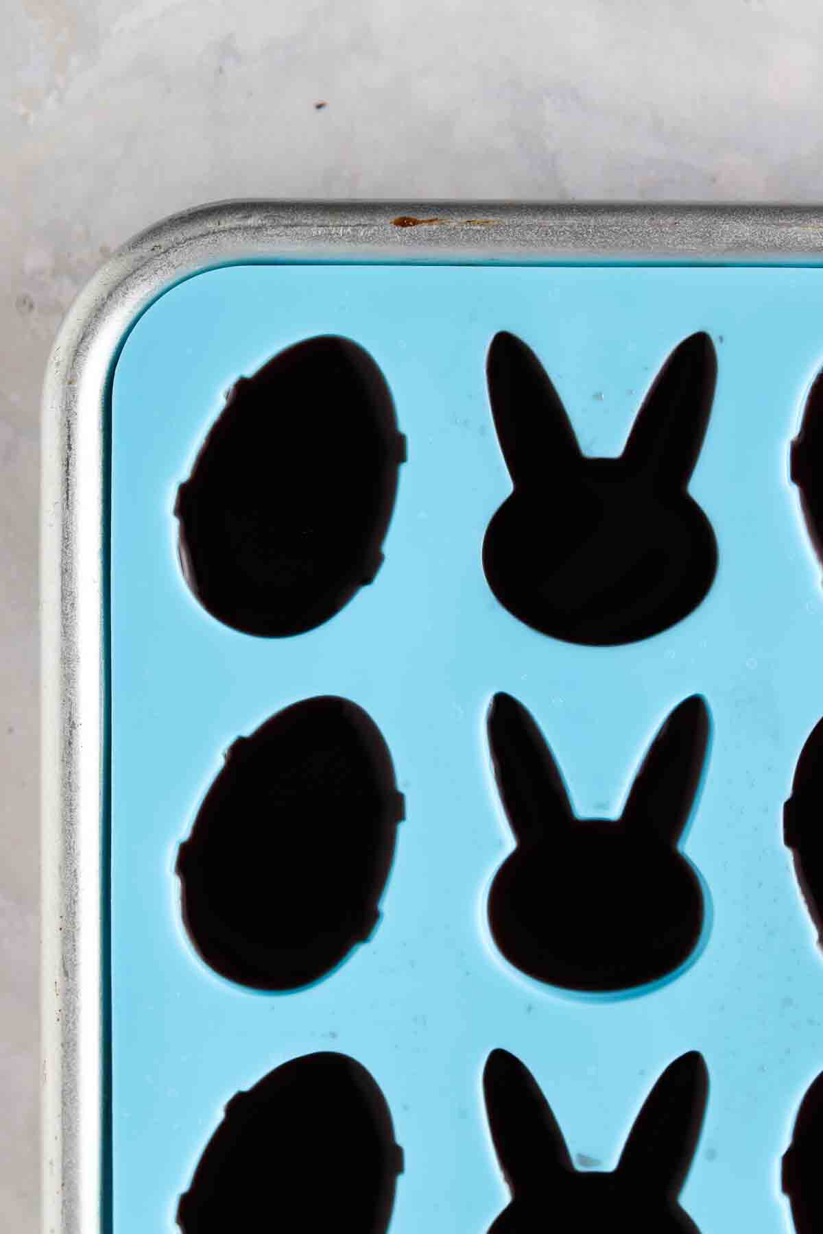 Jello in a blue silicone easter mold setting on the counter. 