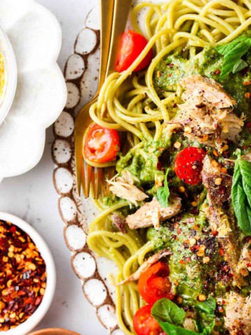 overhead shot of pasta with fresh pesto on top with mackerel