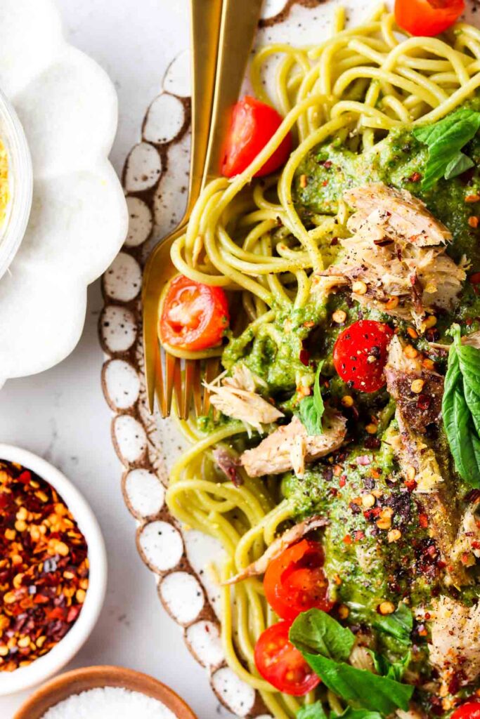 overhead shot of pasta with fresh pesto on top with mackerel