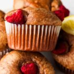 raspberry muffins stacked on a plate