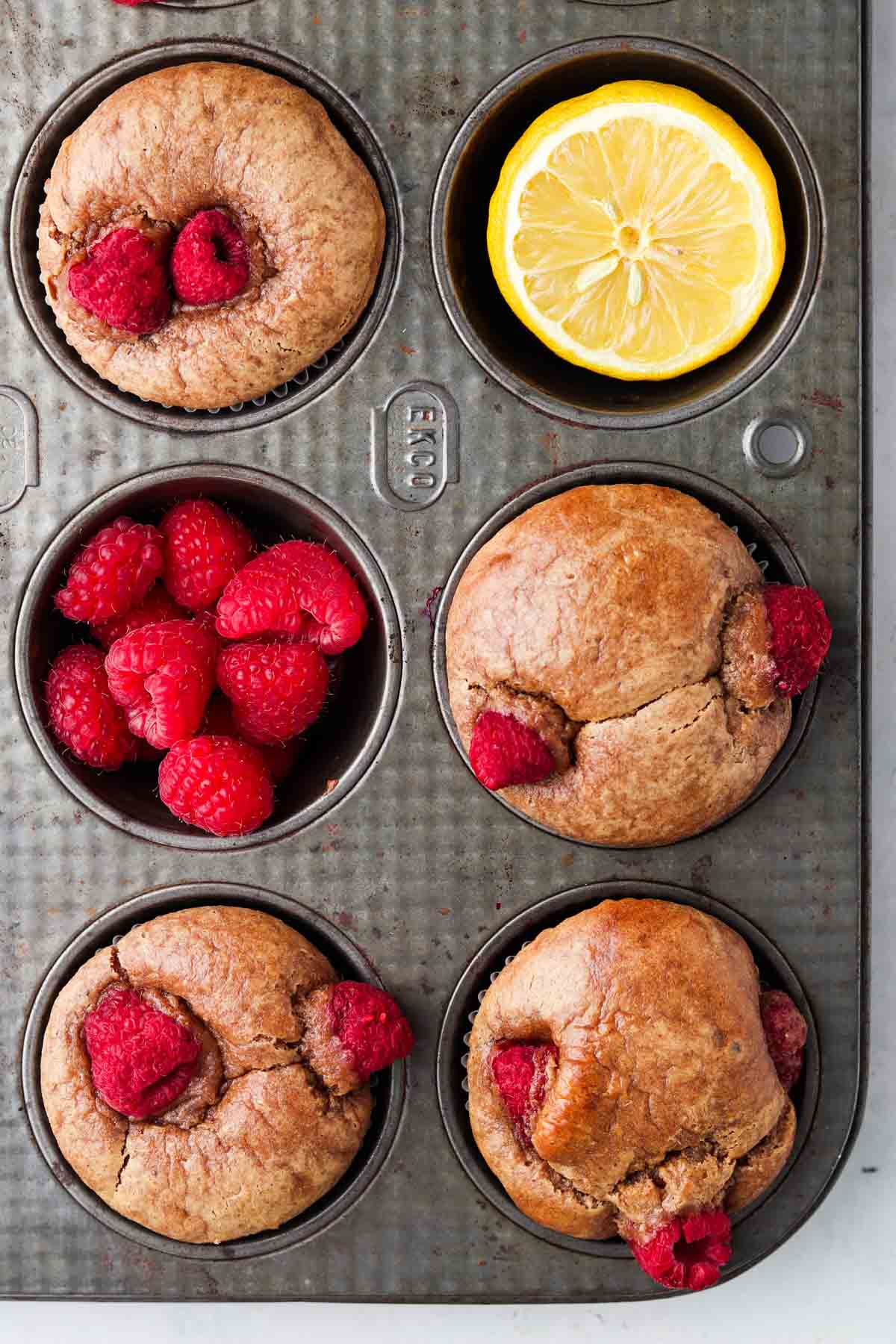 Raspberry lemon muffins in a muffin pan.