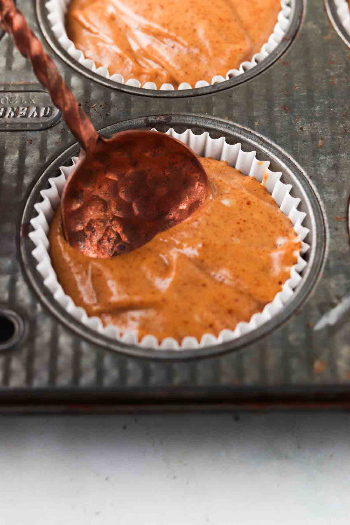 Muffin batter in the muffin pan.