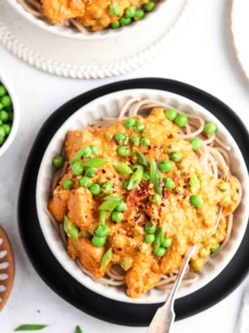 cajun chicken over pasta in a bowl