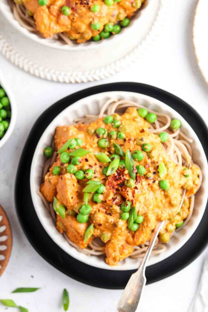 cajun chicken over pasta in a bowl