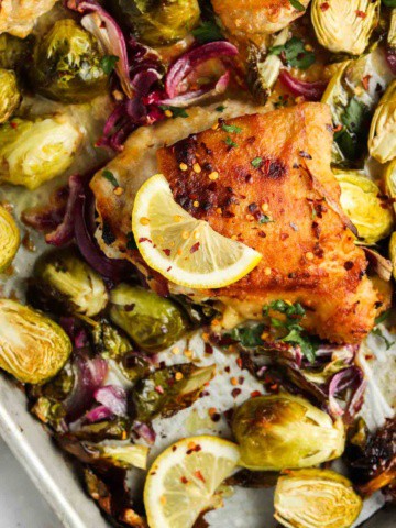 cooked chicken thighs on a sheet pan