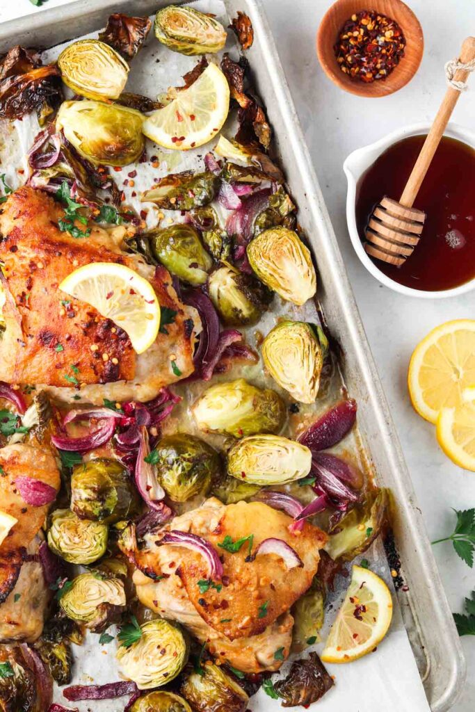 brussel sprouts, onions and chicken on a sheet pan