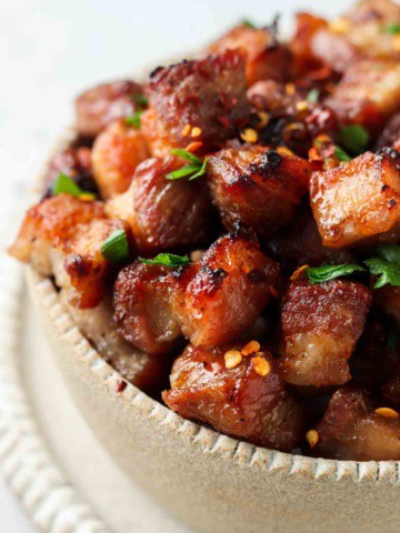 close up photo of pork belly in a bowl