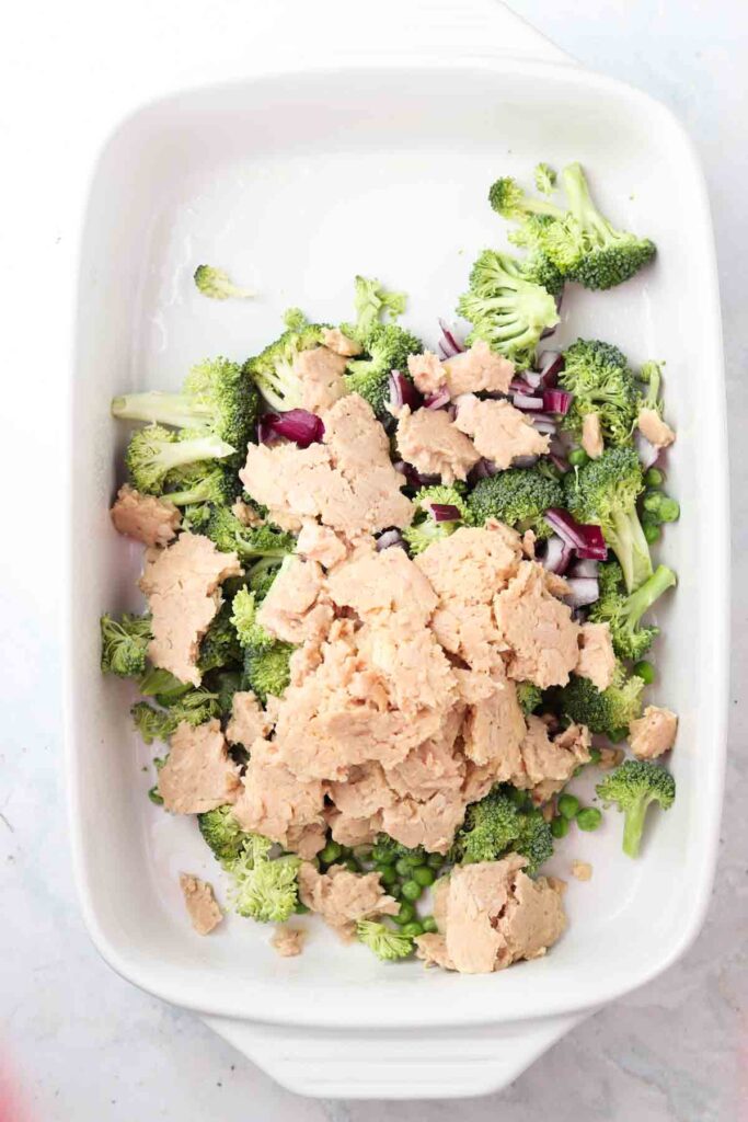 tuna, broccoli, and peas in a casserole dish