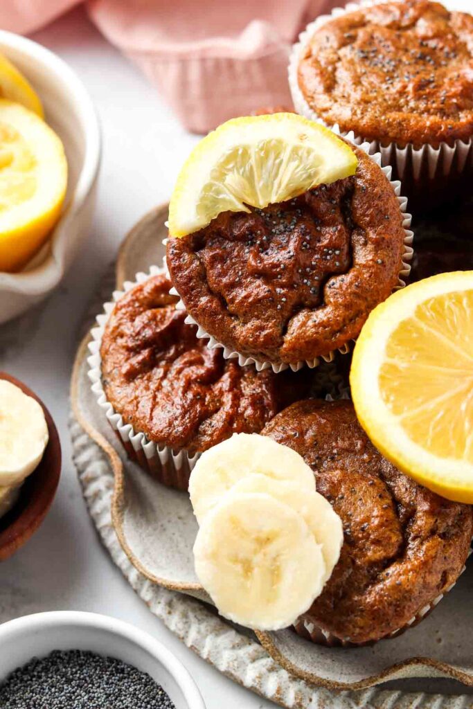 poppyseed muffins on a plate with lemons