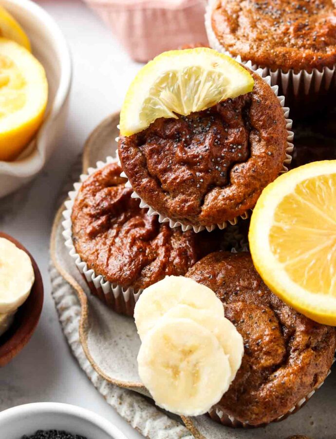 poppyseed muffins on a plate with lemons