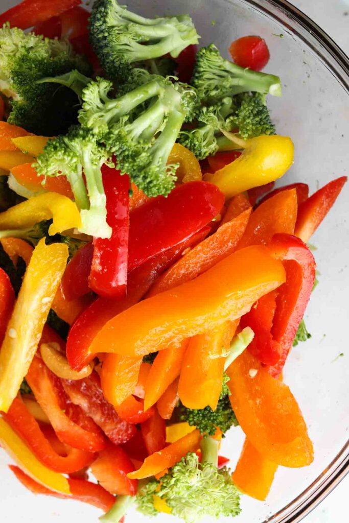 peppers, broccoli, cashews and oil in a bowl