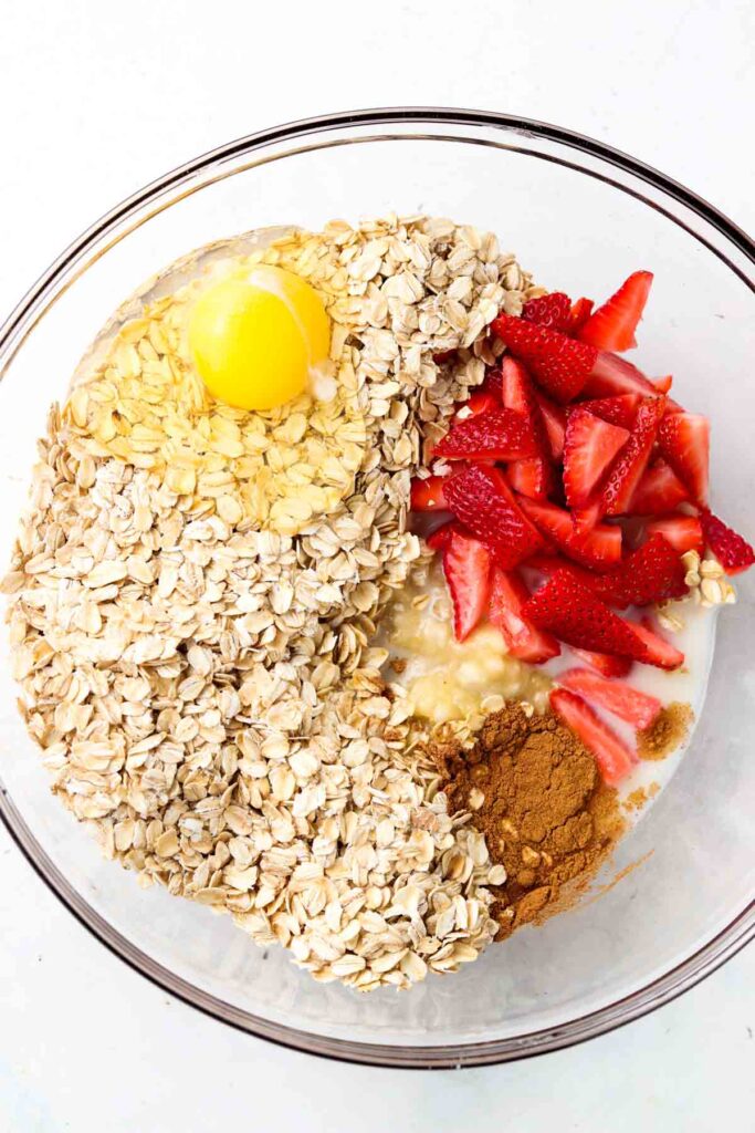 oats, banana, strawberries, cinnamon, coconut milk in a bowl