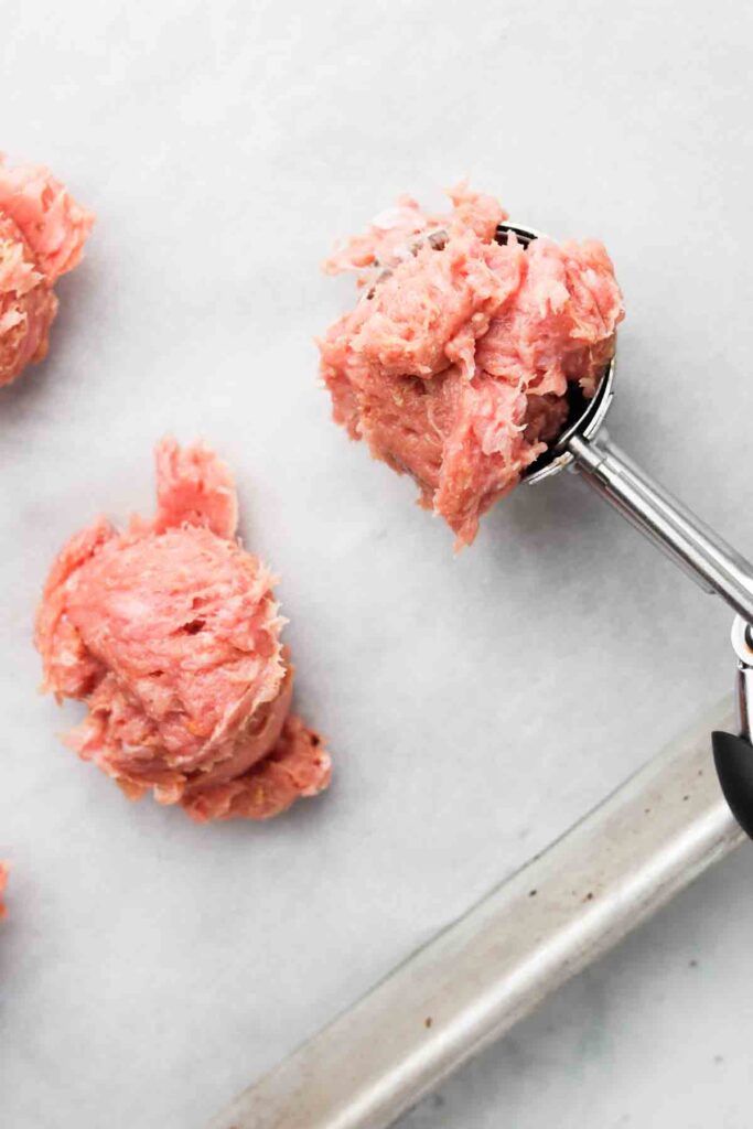 meatballs scooped on to a baking sheet