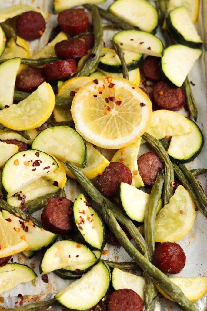 sausage, yellow squash, zucchini and green beans on a sheet pan