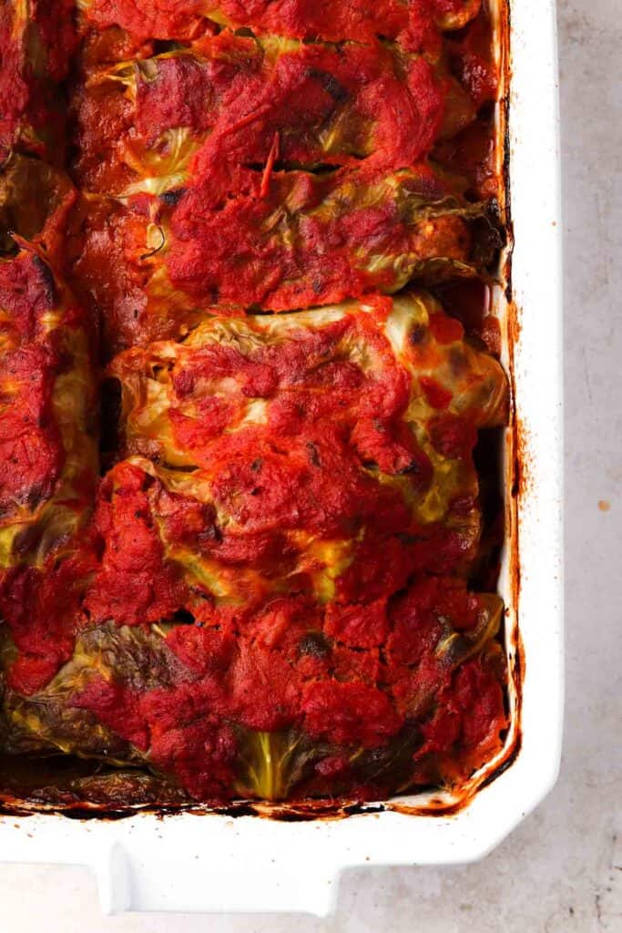 Cooked stuffed cabbage in a casserole dish.