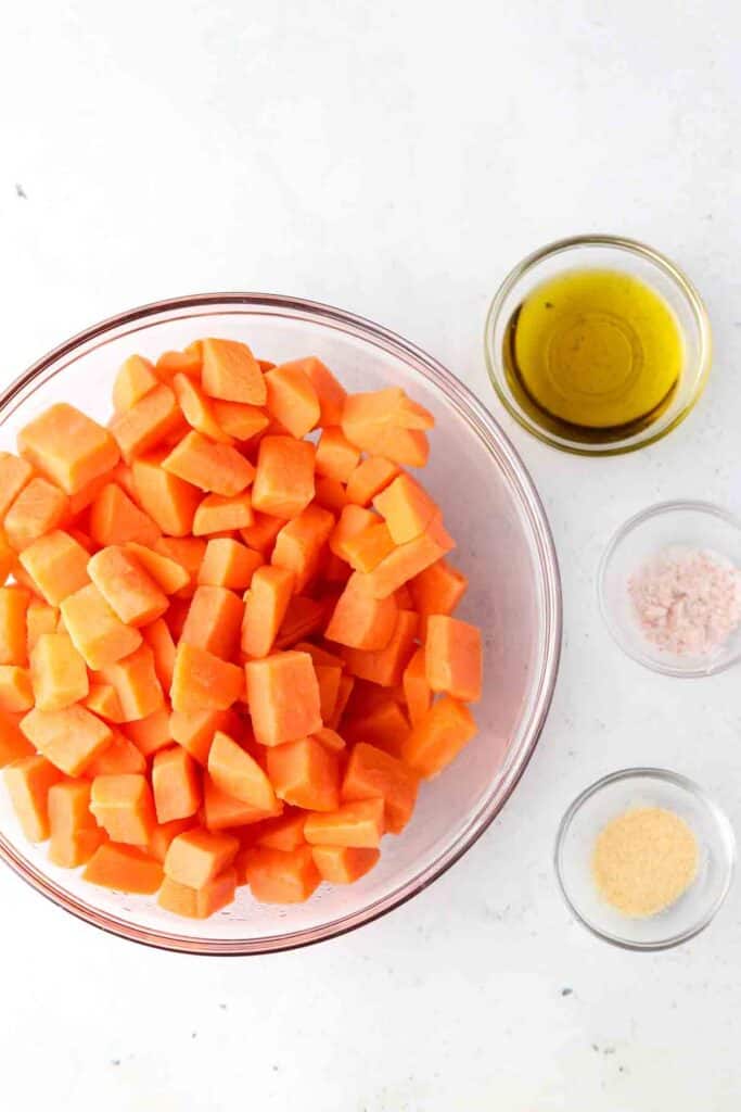 sweet potatoes, oil, salt and garlic powder laid out in bowls