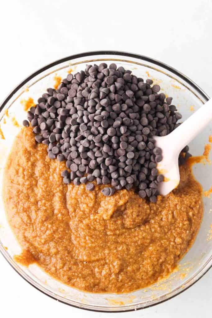 chocolate chips in a bowl with the pumpkin bread ingredients 