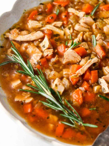 close up photo of turkey soup in a bowl