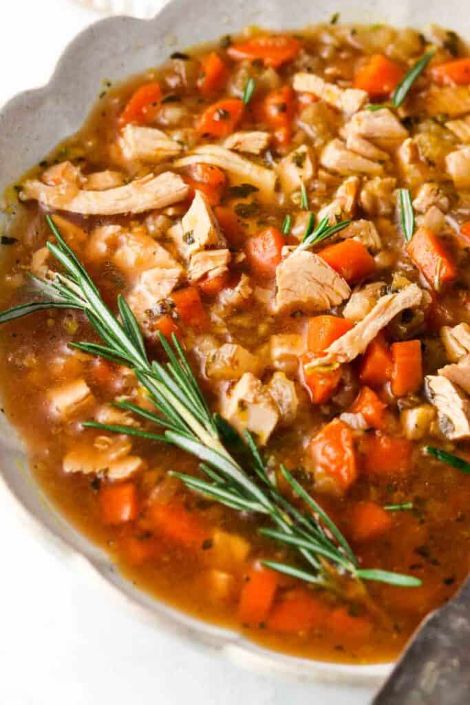 close up photo of turkey soup in a bowl