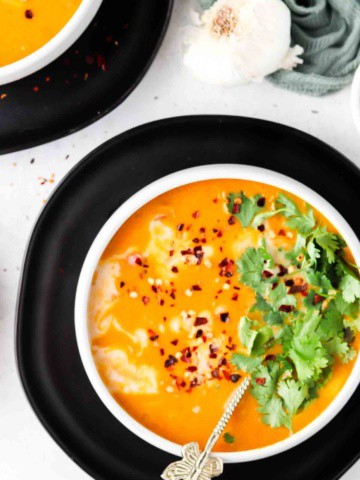 overhead shot of pumpkin soup in bowls