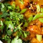 butternut squash in a bowl with fresh herbs on top