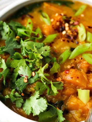 butternut squash in a bowl with fresh herbs on top