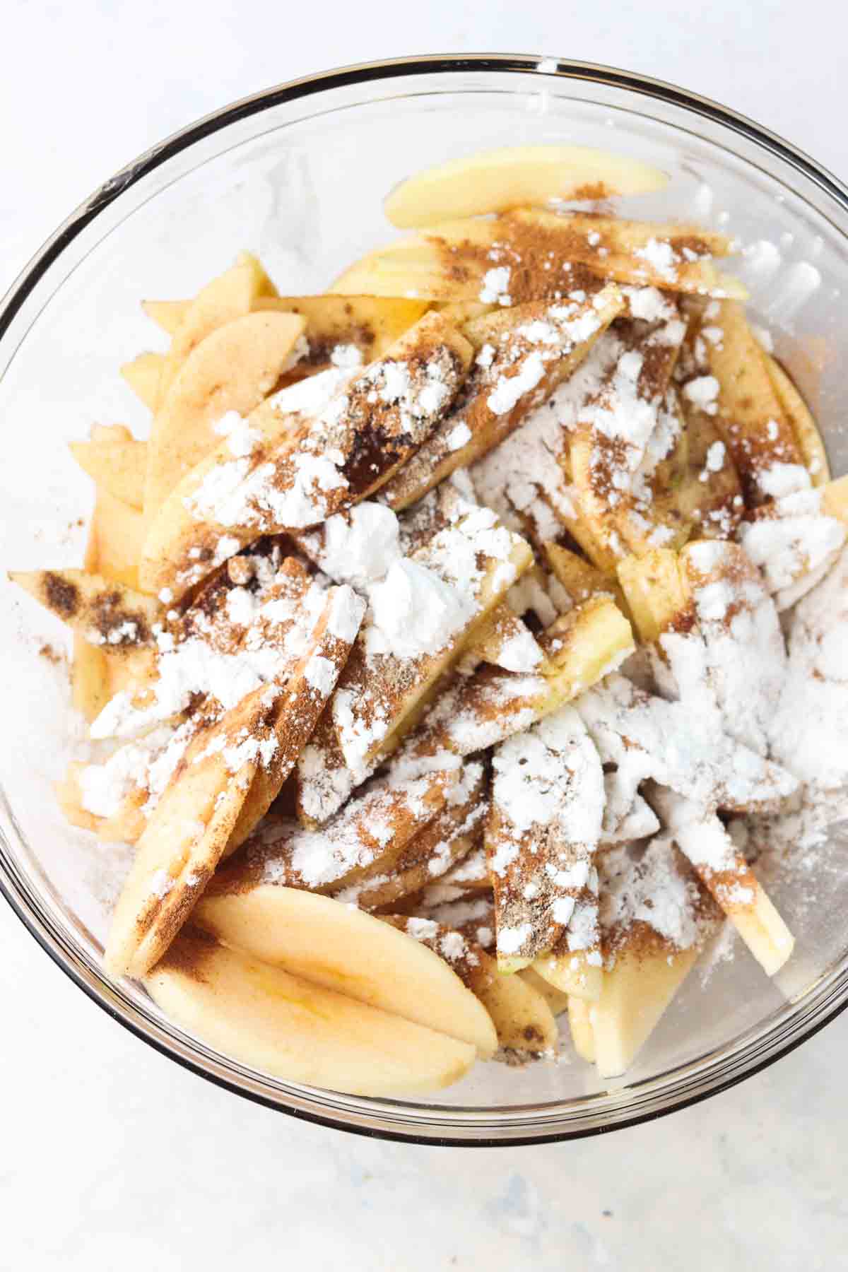 apples, baking soda, and spices mixed in a bowl