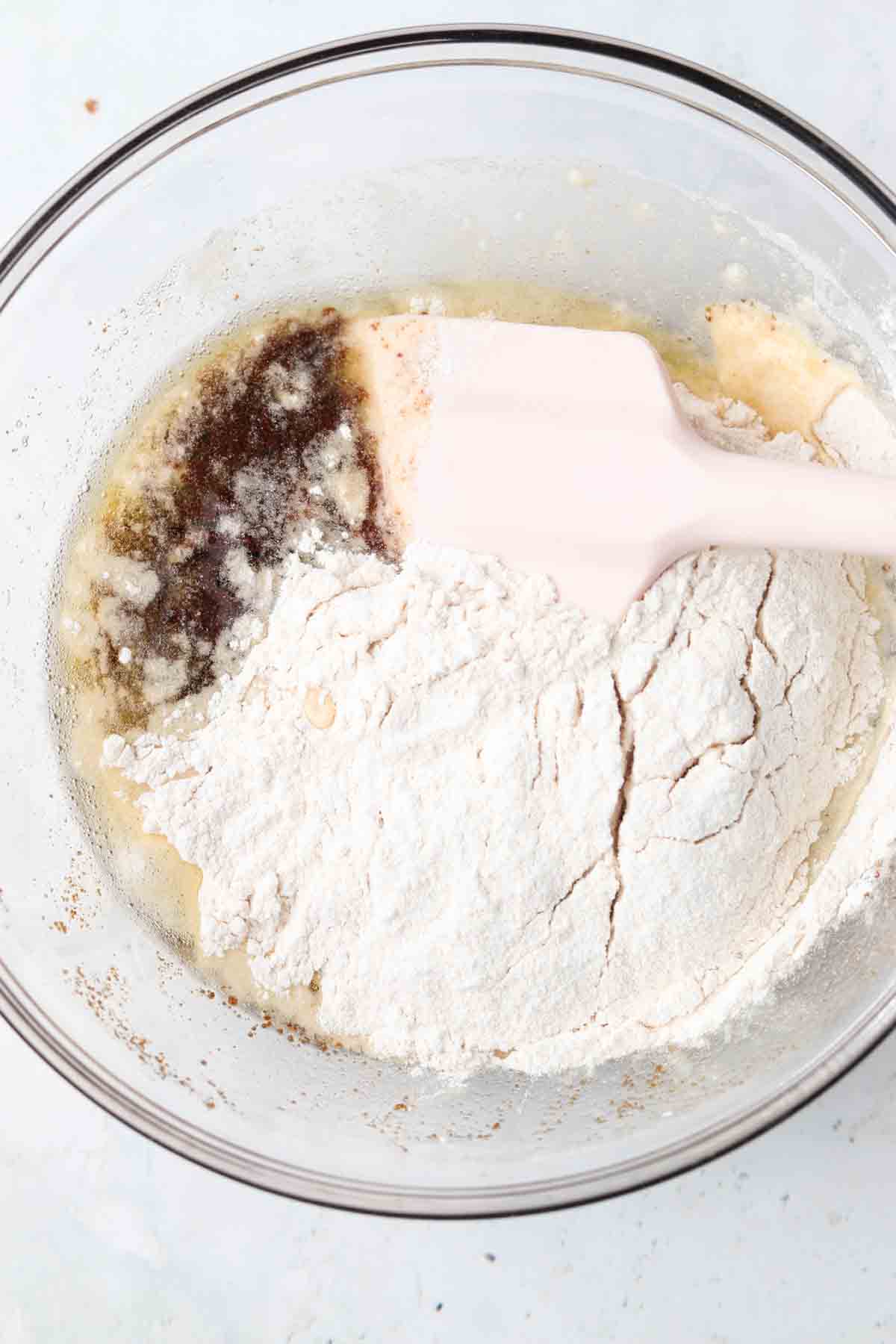 Gluten free lemon bars shortbread mixture in a bowl with spatula.