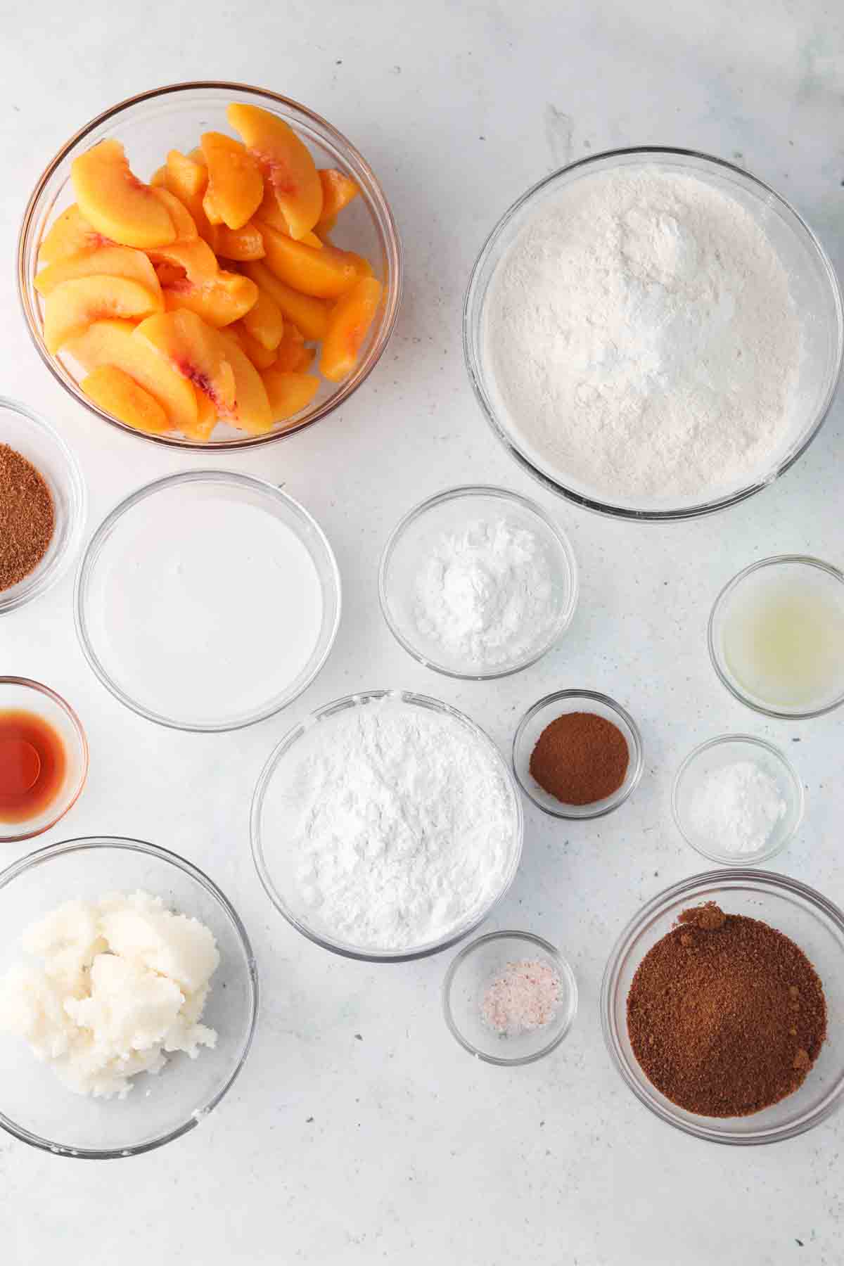 peach cobbler ingredients laid out in bowls