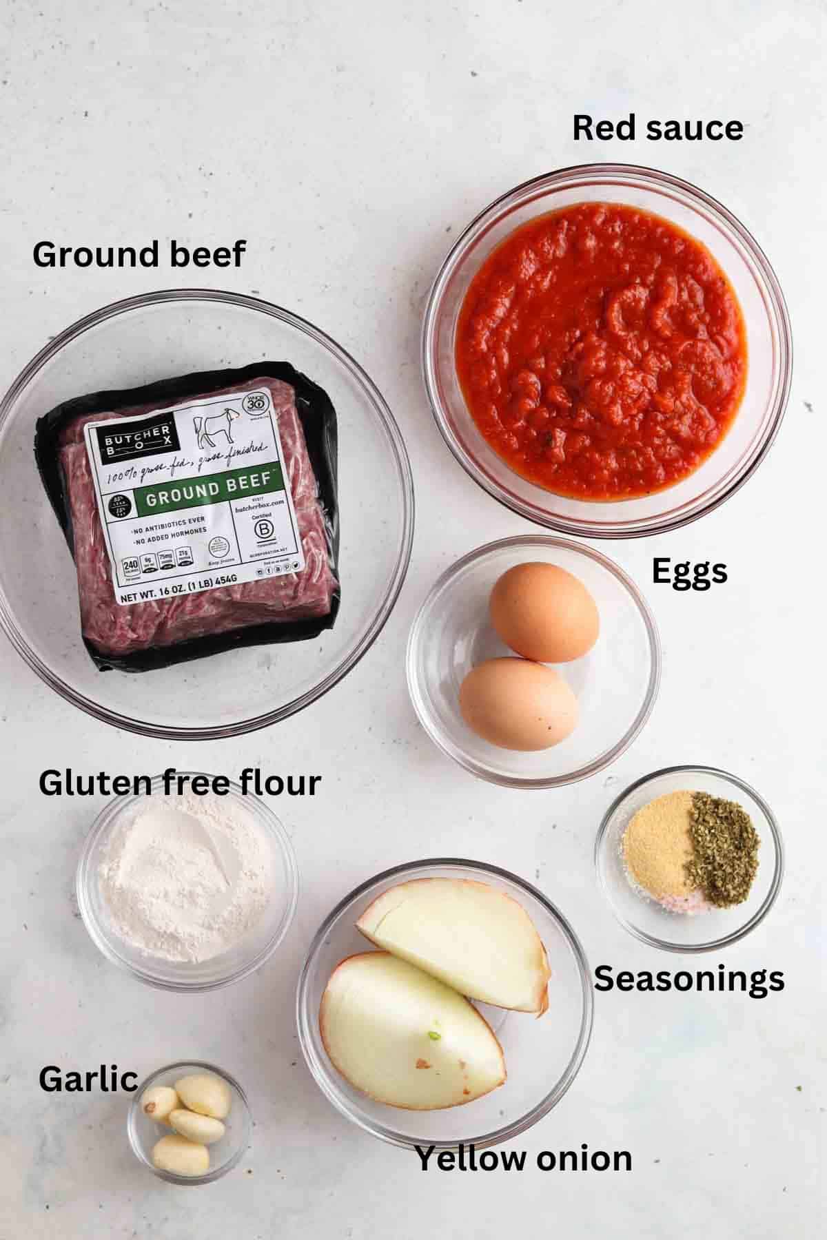 Gluten free meatball ingredients laid out in glass bowls.