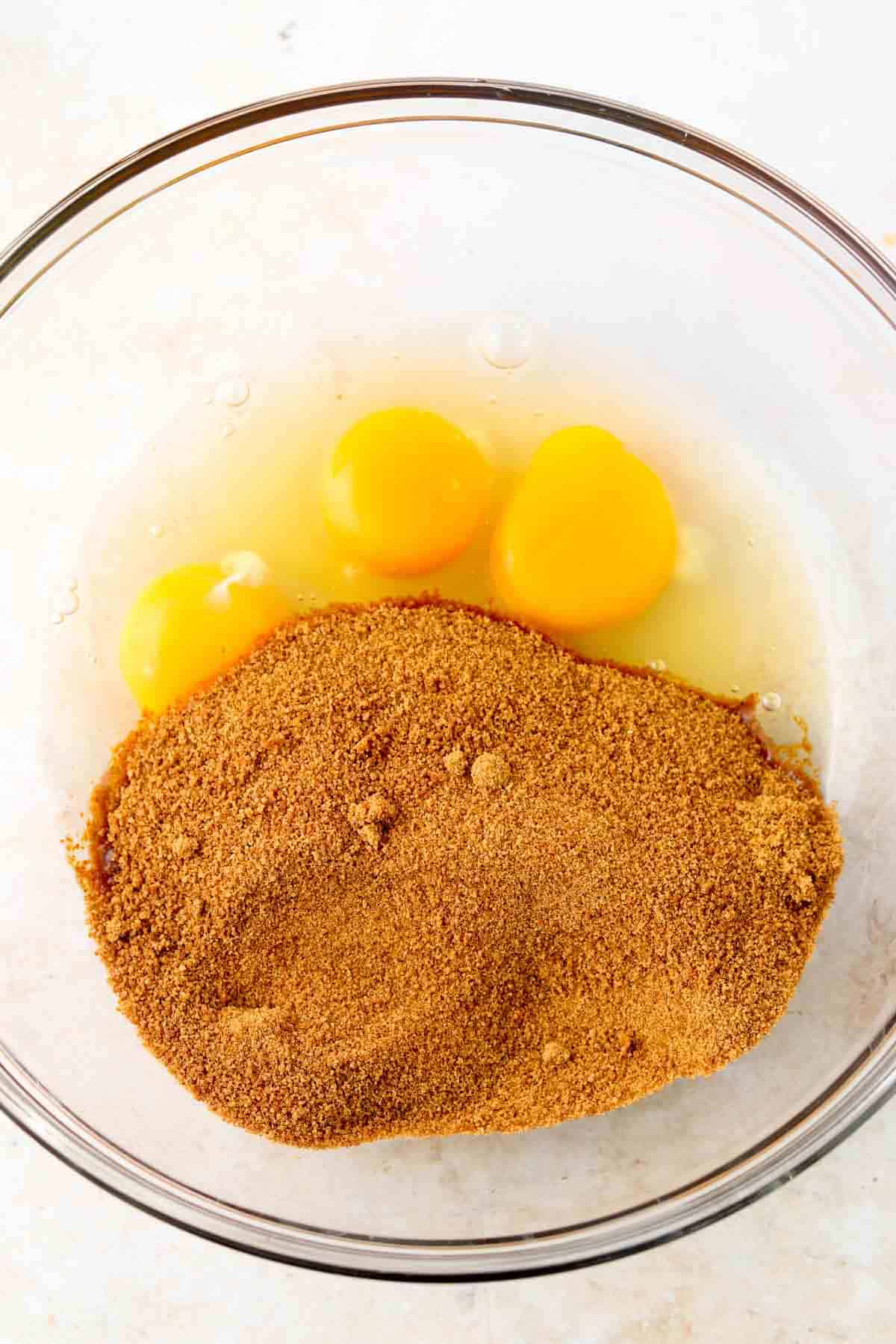 Coconut sugar and eggs in a bowl.