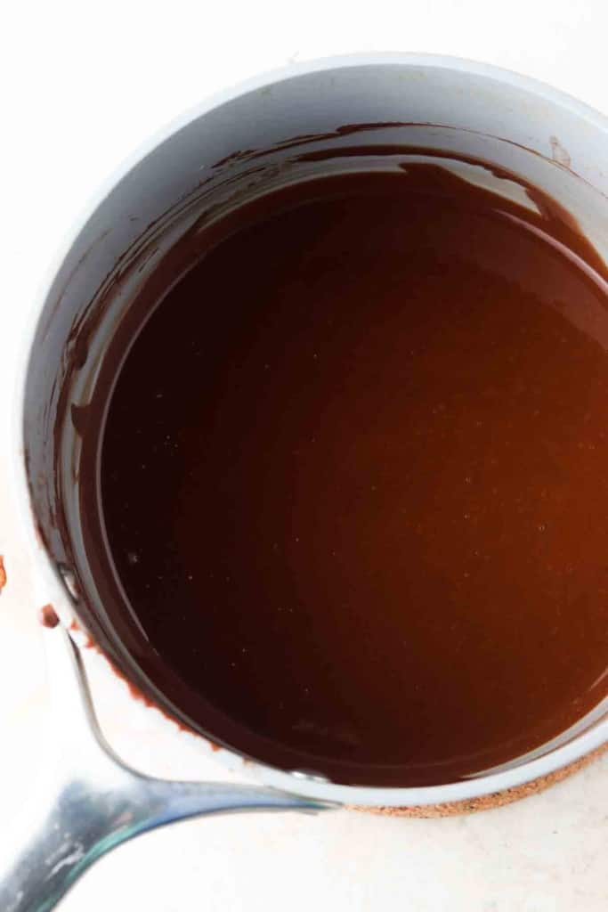 Smooth melted chocolate sauce in a pan.