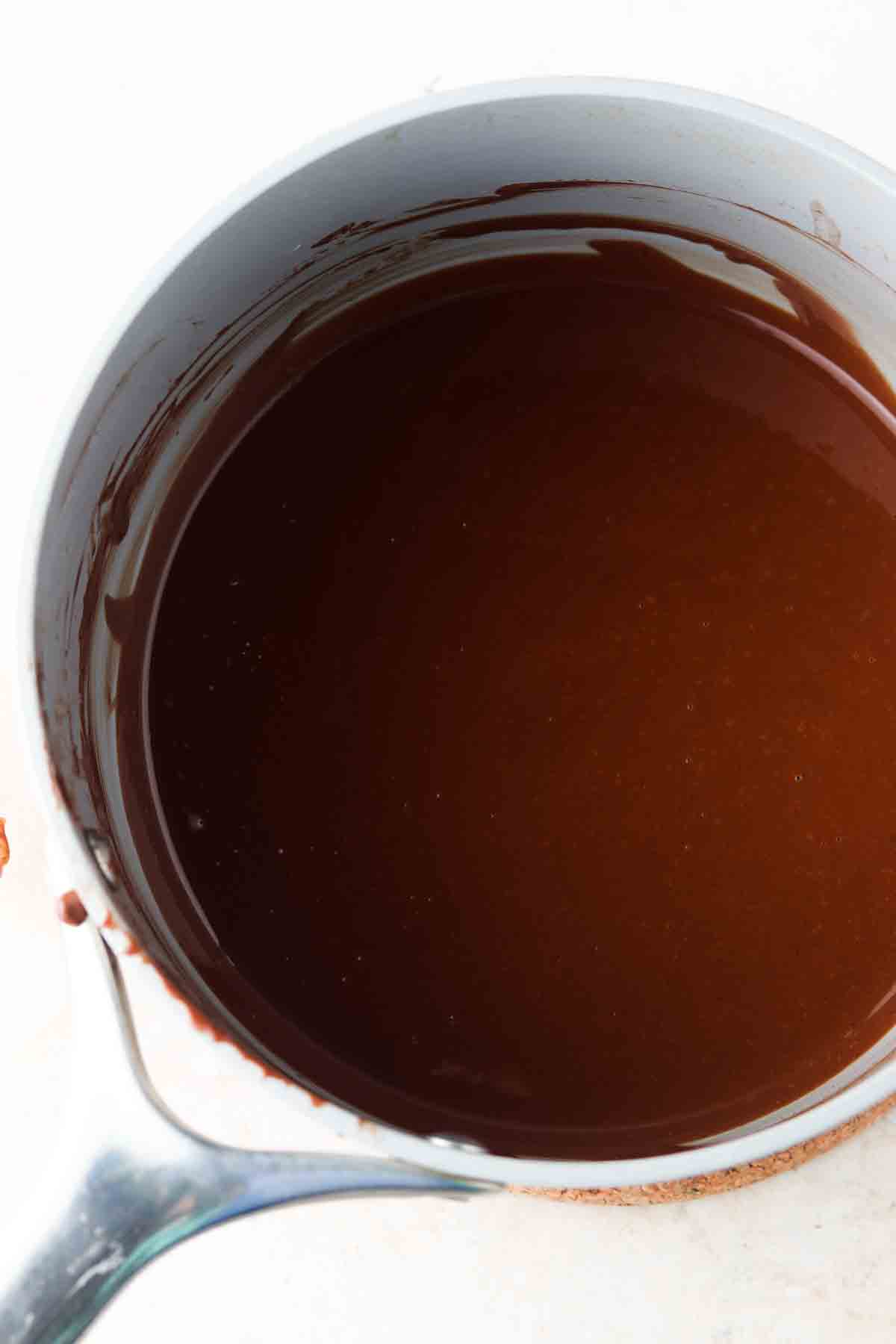 Smooth melted chocolate sauce in a pan.