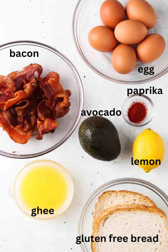 Dairy free hollandaise ingredients in small glass bowls on a marble background.