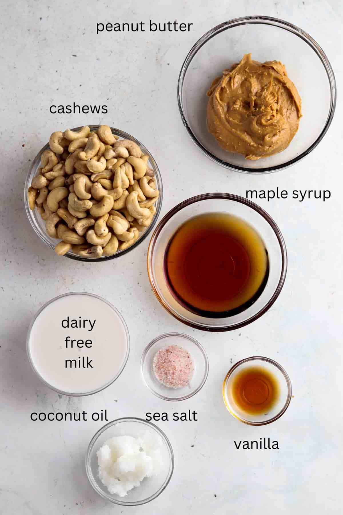 Peanut butter cheesecake filling ingredients laid out in clear bowls.
