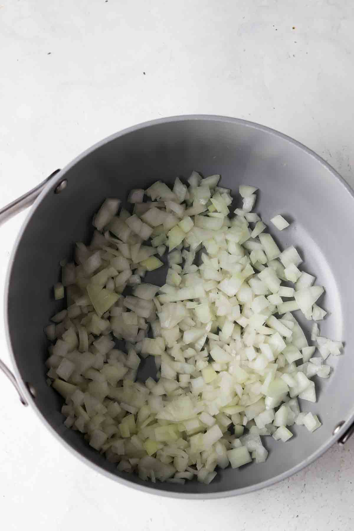 Onions diced up in a dutch pan.