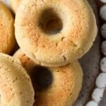 Bagels stacked on pretty scalloped plate.