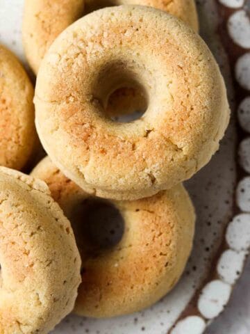 Bagels stacked on pretty scalloped plate.