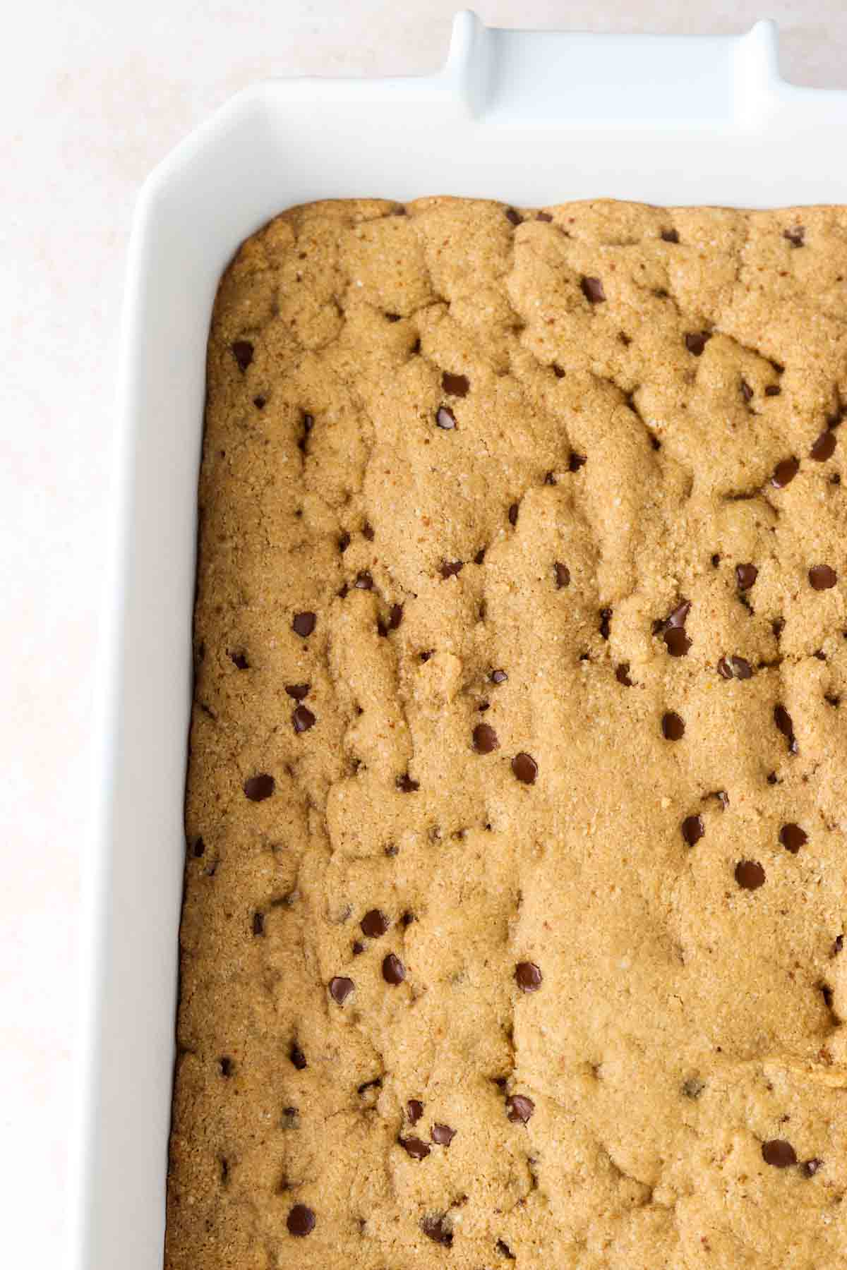 Gluten free cookie cake cooling in a casserole dish.