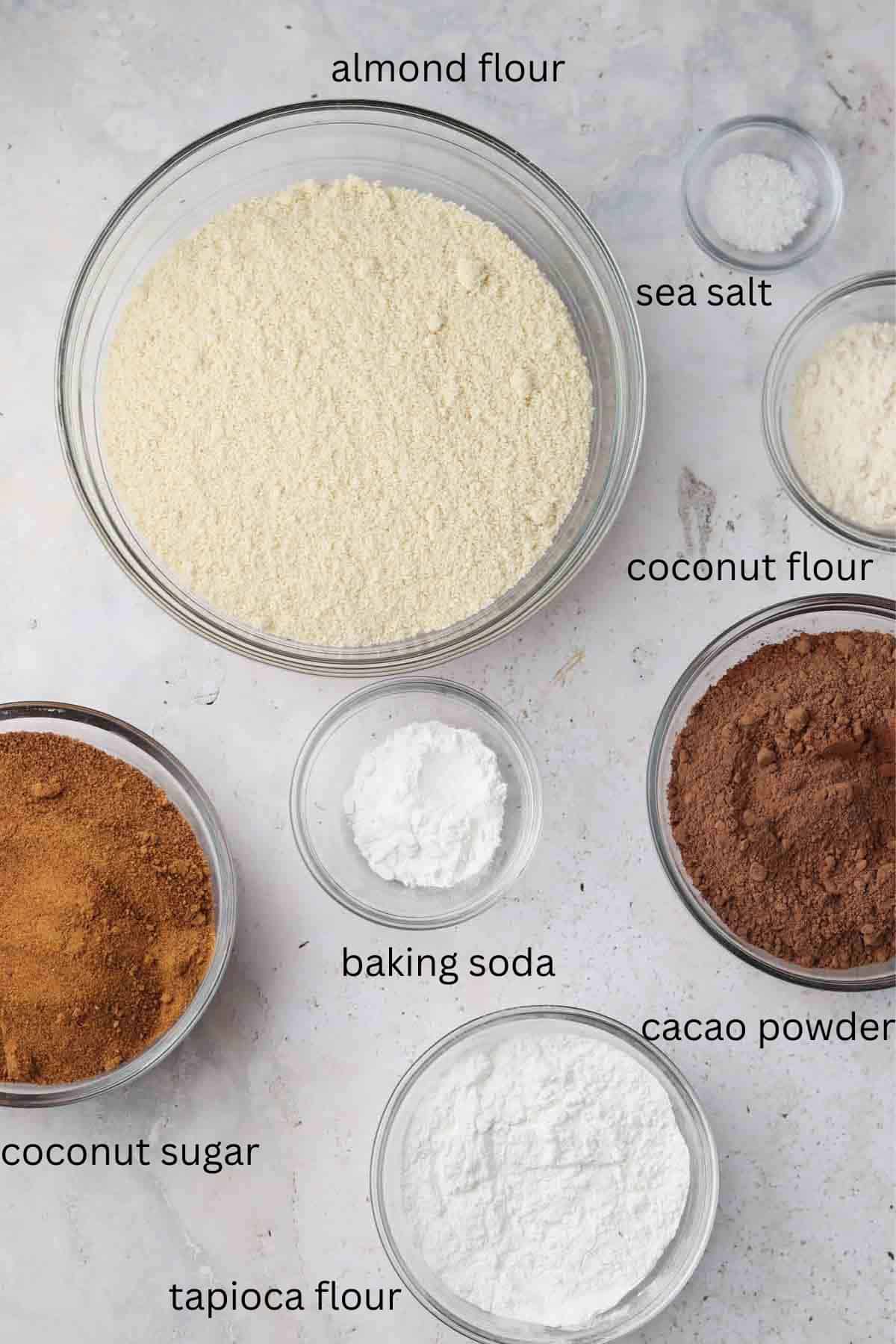 Gluten free chocolate cake ingredients in small glass bowls on the counter. 