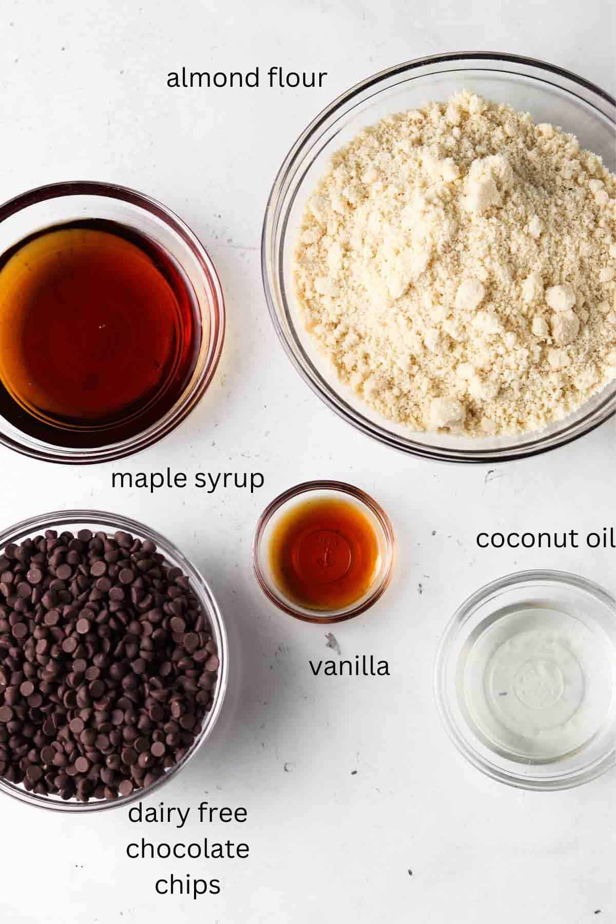 Cake pop ingredients laid out in small glass bowls on the counter top.