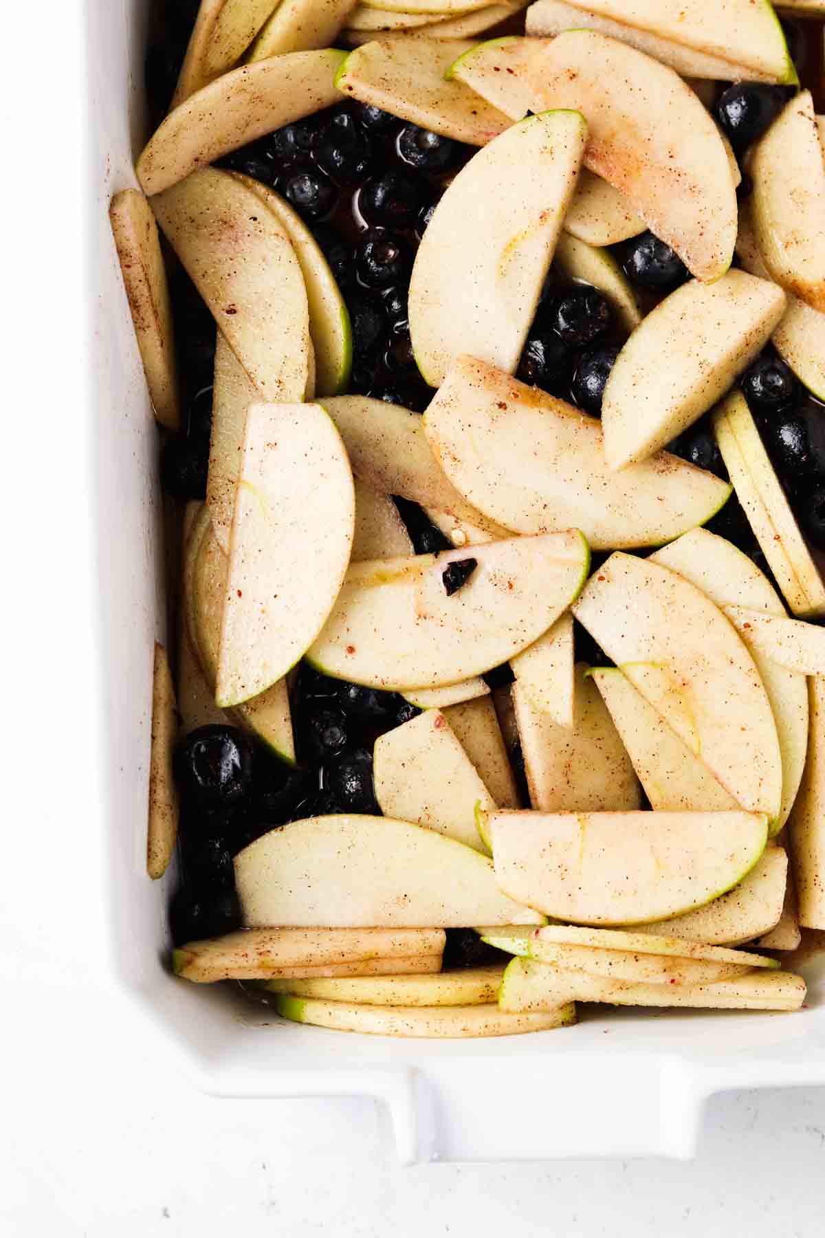 Mixed blueberries and apple mixture in a casserole dish.