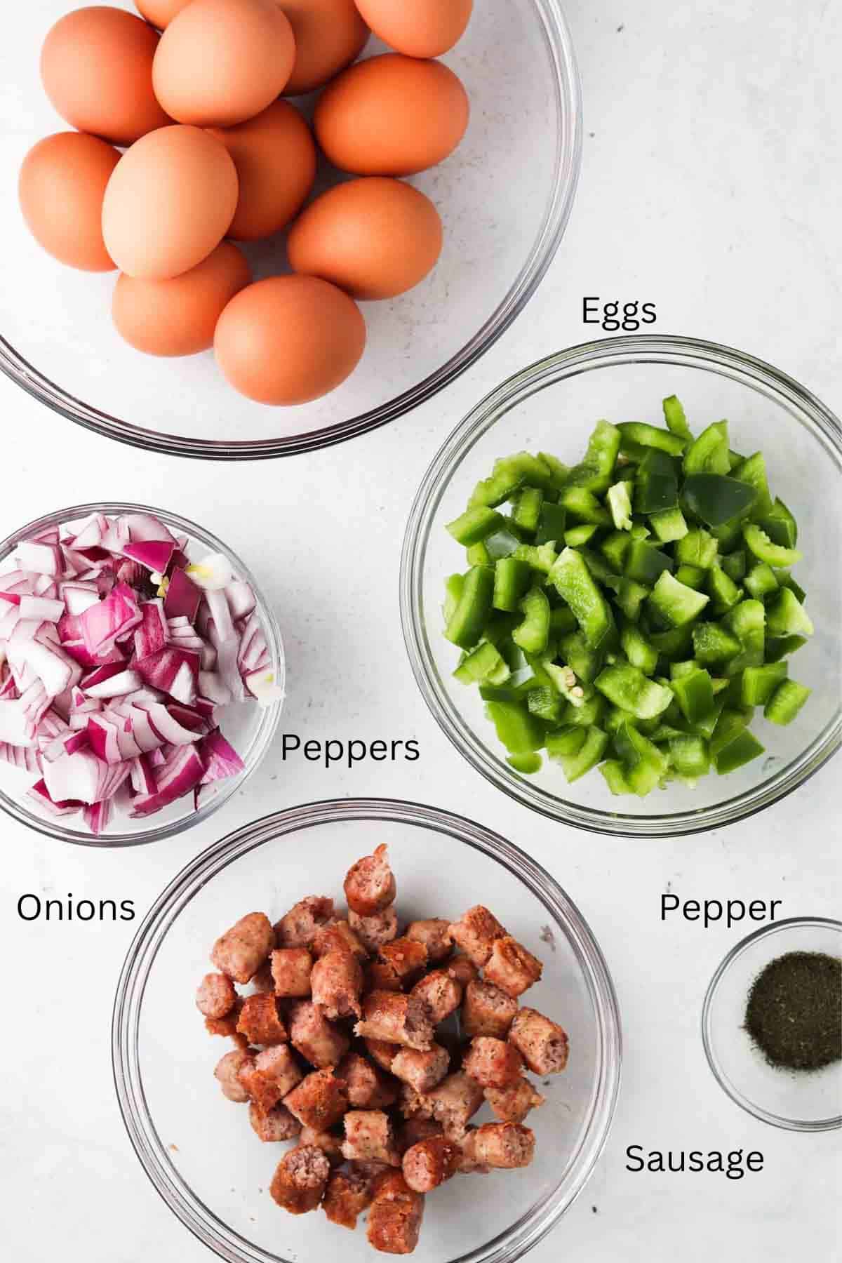 Egg frittata ingredients in glass bowls.