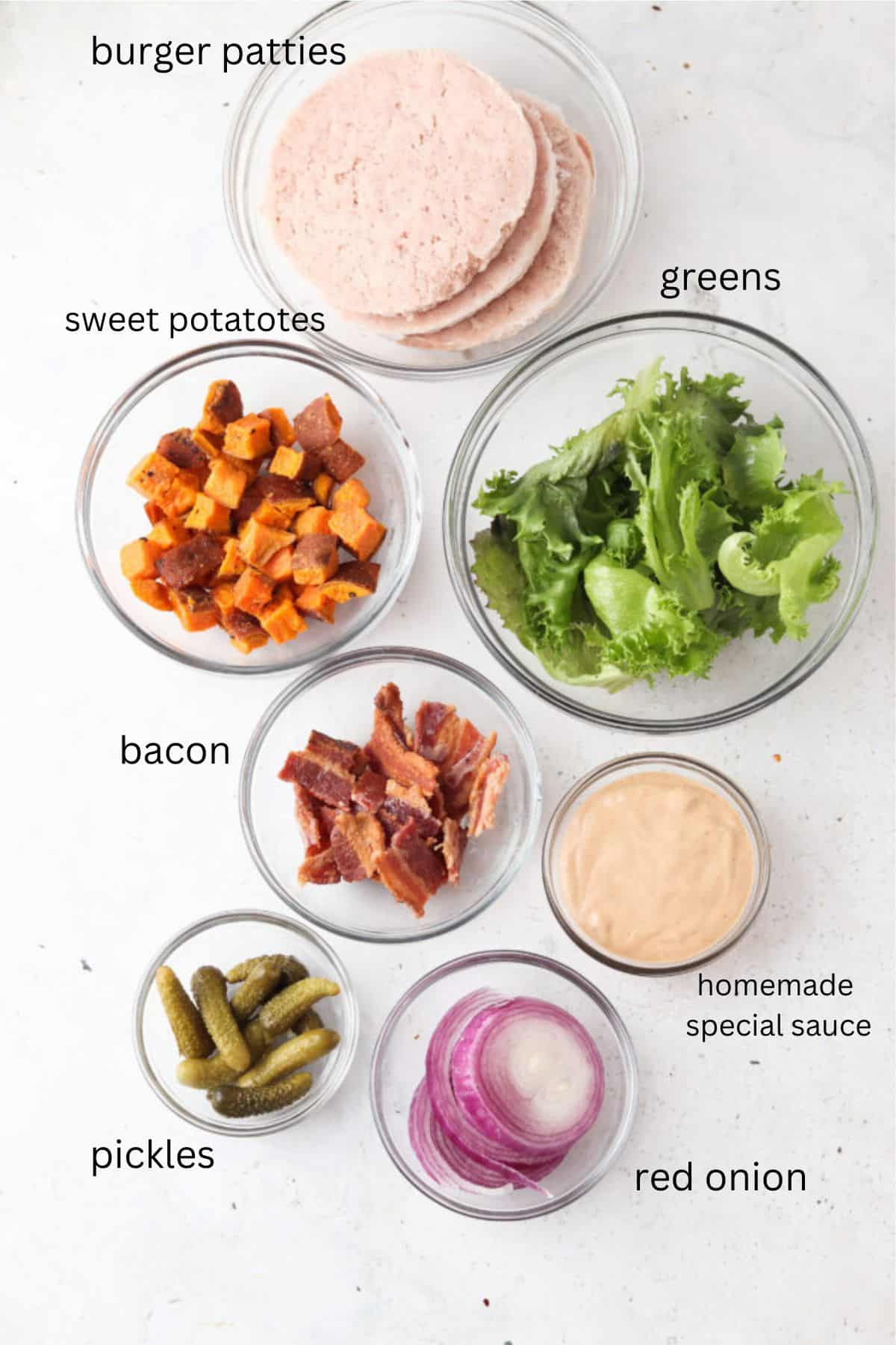 Deconstructed burger bowl ingredients in small glass bowls.