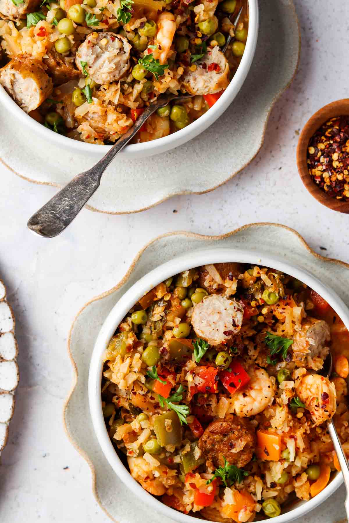 Overhead shot of paella in two small bowls with a fork in them. 