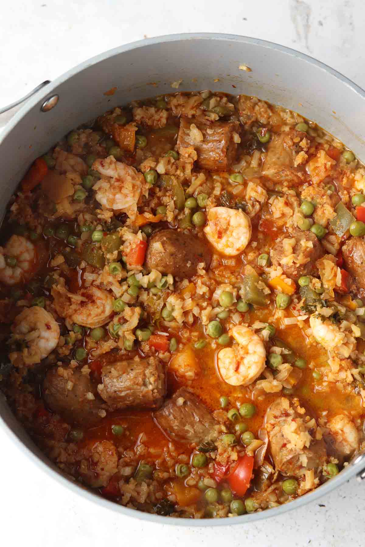 Paella inside a dutch oven on the counter top.