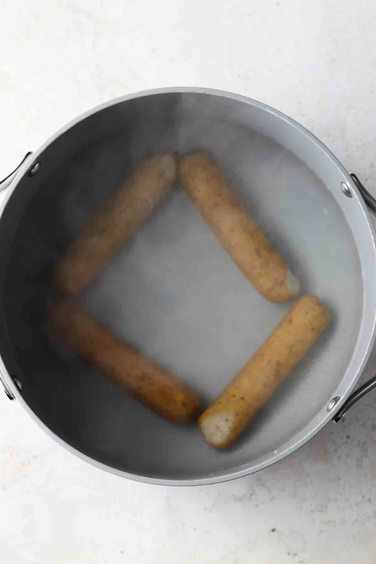 Sausage in a large pot of boiling water. 